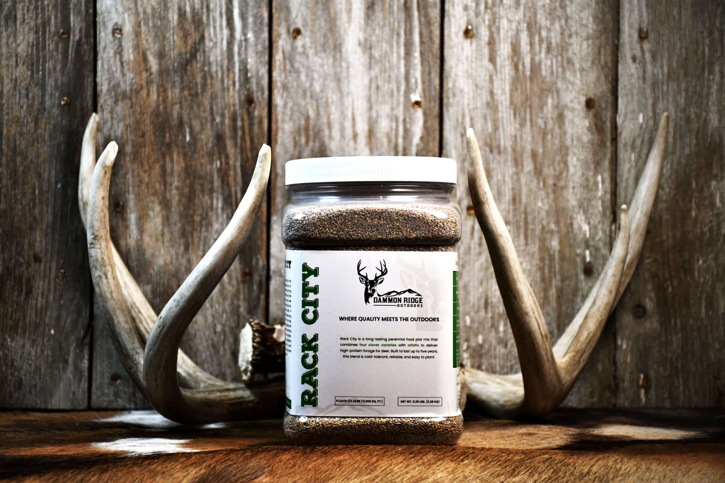 Rack City food plot seed jar between whitetail deer antlers by Dammon Ridge Outdoors